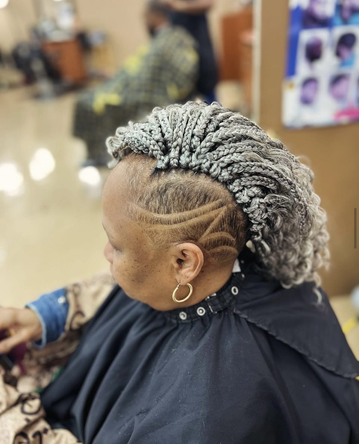 Braided style with shaved line design at Headlines Barbershop